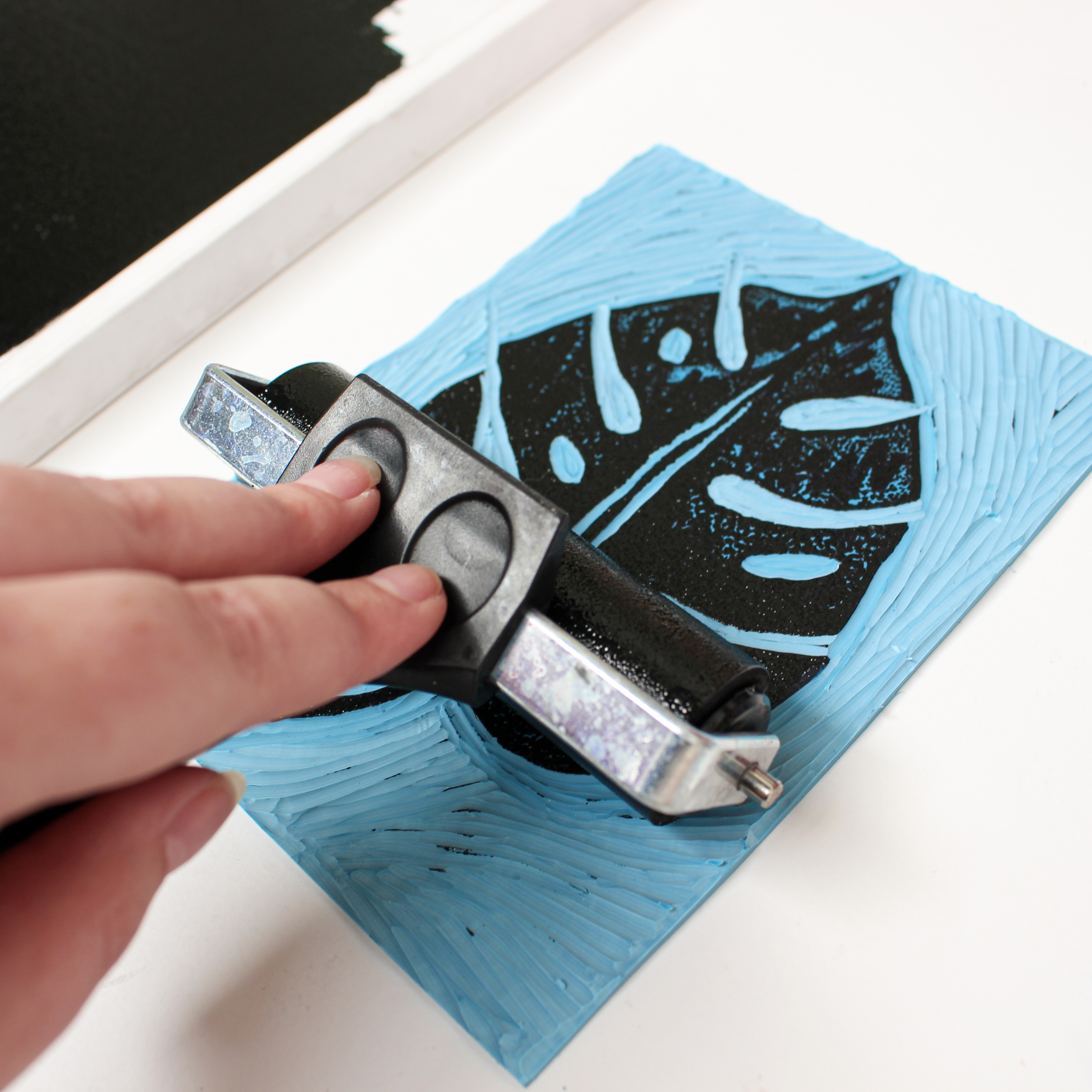 Rolling the ink on the carved Linoleum