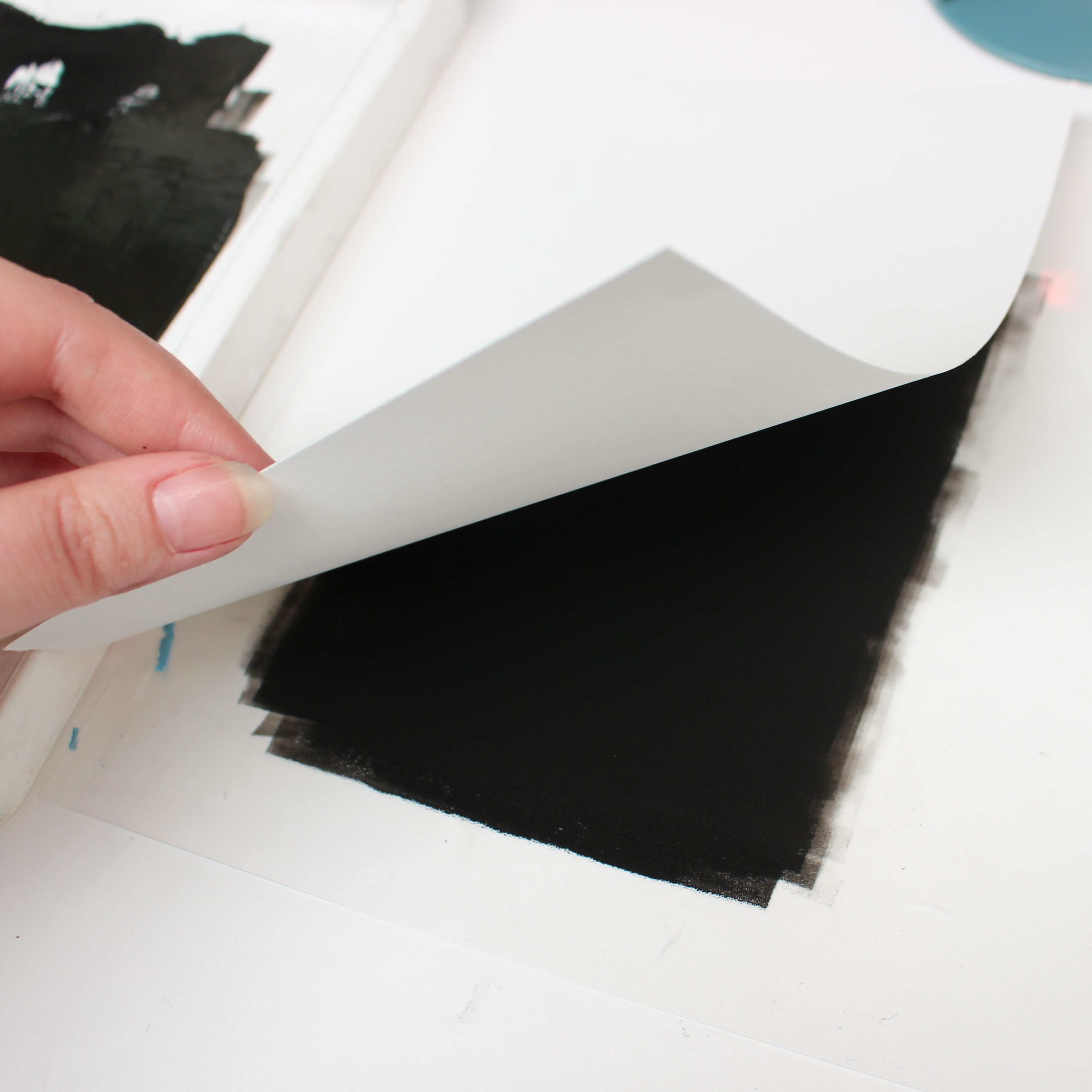placing paper onto the ink